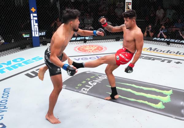 LAS VEGAS, NEVADA – OCTOBER 14: (R-L) Jonathan Martinez kicks Adrian Yanez in a bantamweight fight during the UFC Fight Night event at UFC APEX on October 14, 2023 in Las Vegas, Nevada. (Photo by Chris Unger/Zuffa LLC via Getty Images)